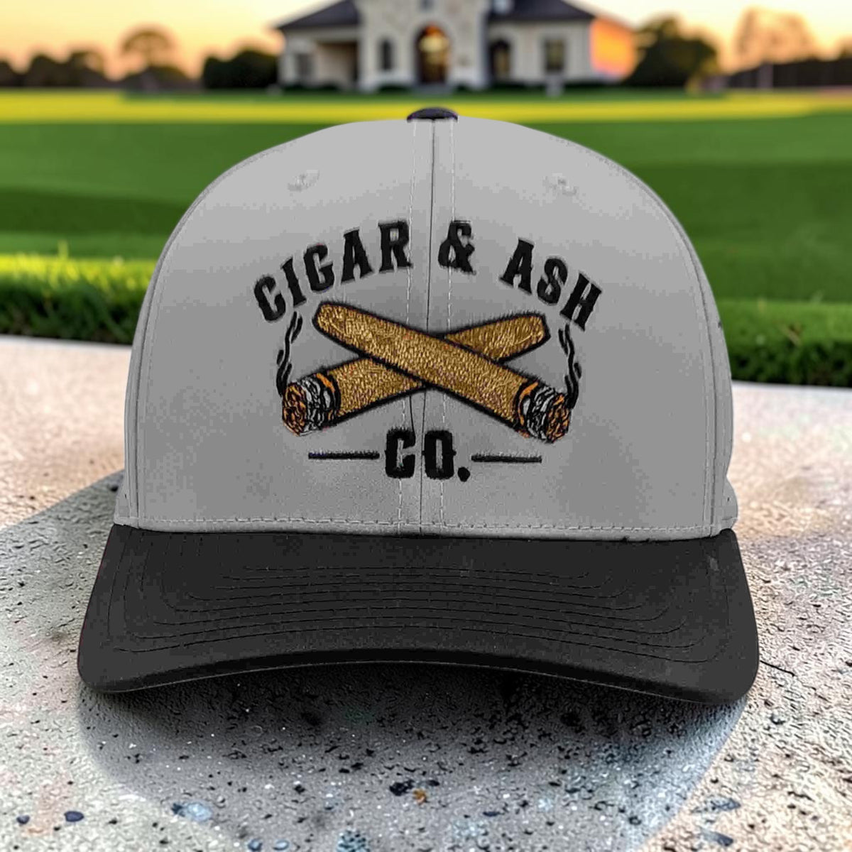 Front view of Cigar & Ash Co. two-tone grey and black laser perforated snapback hat with embroidered logo