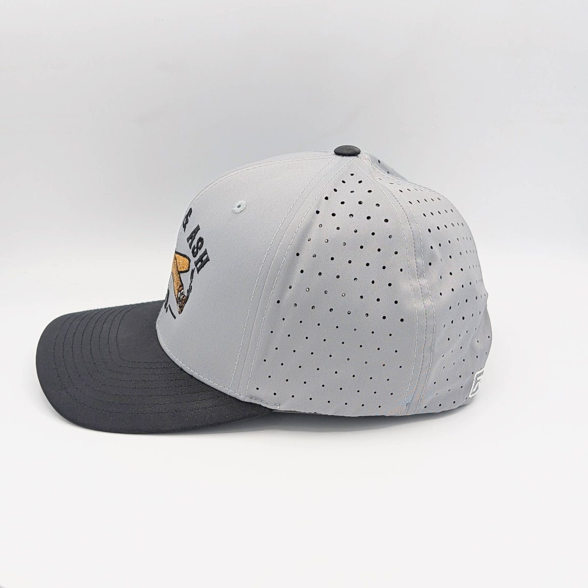Side view of Cigar & Ash Co. two-tone grey and black performance snapback hat highlighting laser perforated airflow panels