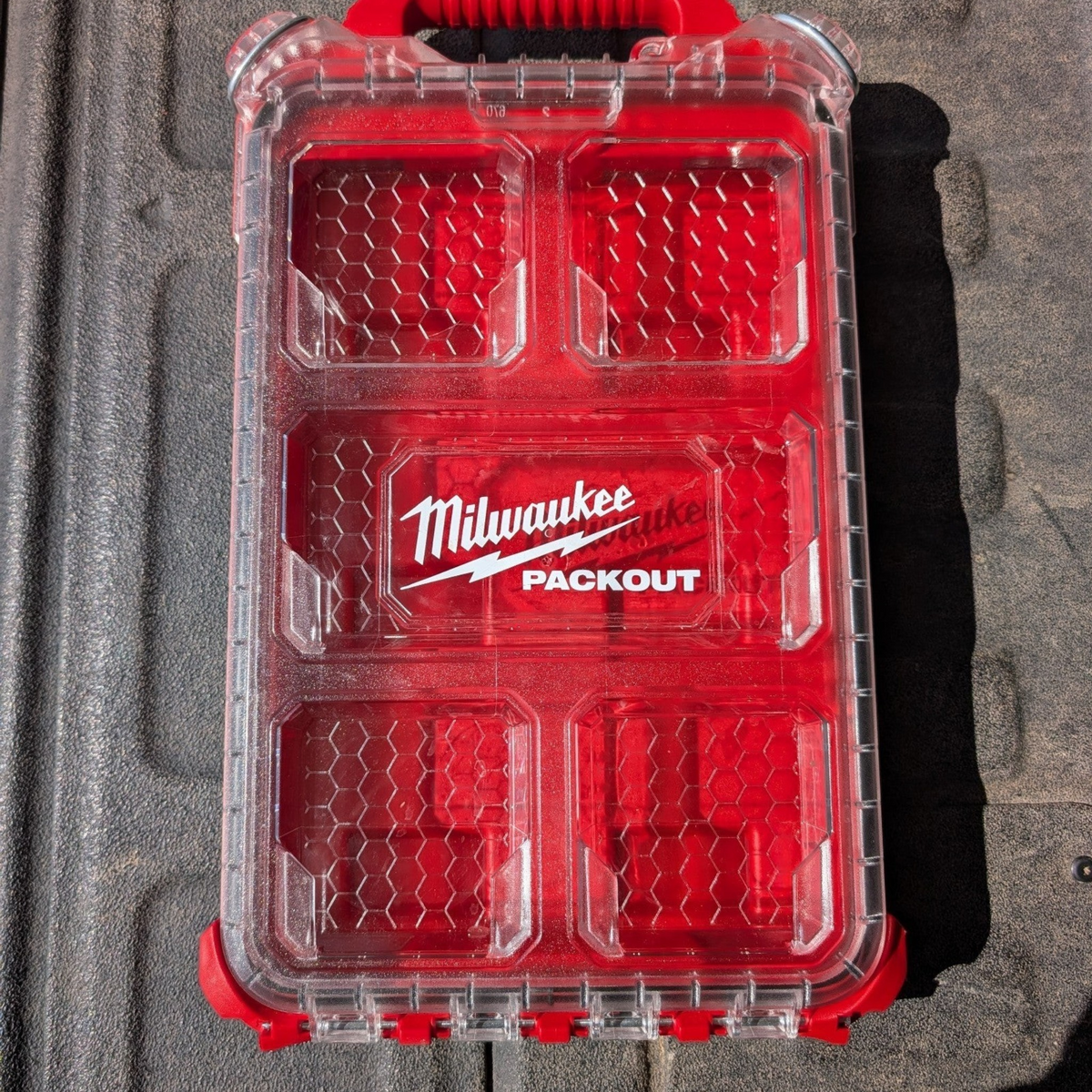 Cigar & Ash Co. Milwaukee Packout compact low-profile organizer shell with a clear lid and red interior base.