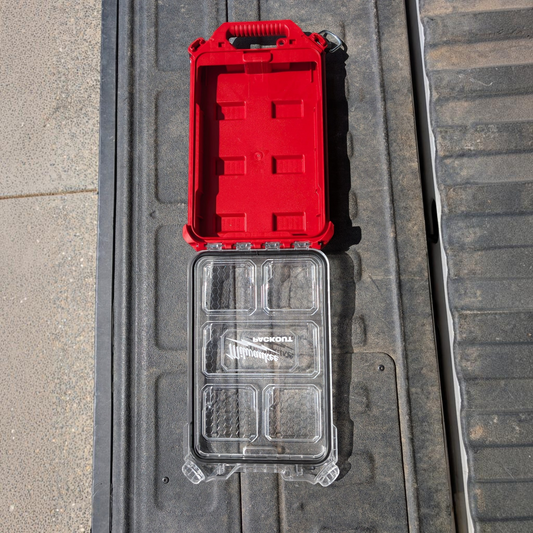 Cigar & Ash Co. Milwaukee Packout compact low-profile organizer shell with red base and clear lid on truck bed