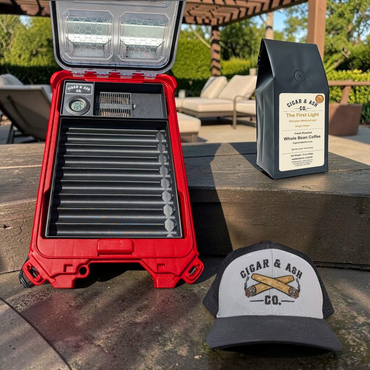 Cigar & Ash Co. Sunrise Roast Bundle featuring a red cigar humidor insert, The First Light coffee, and a snapback hat.