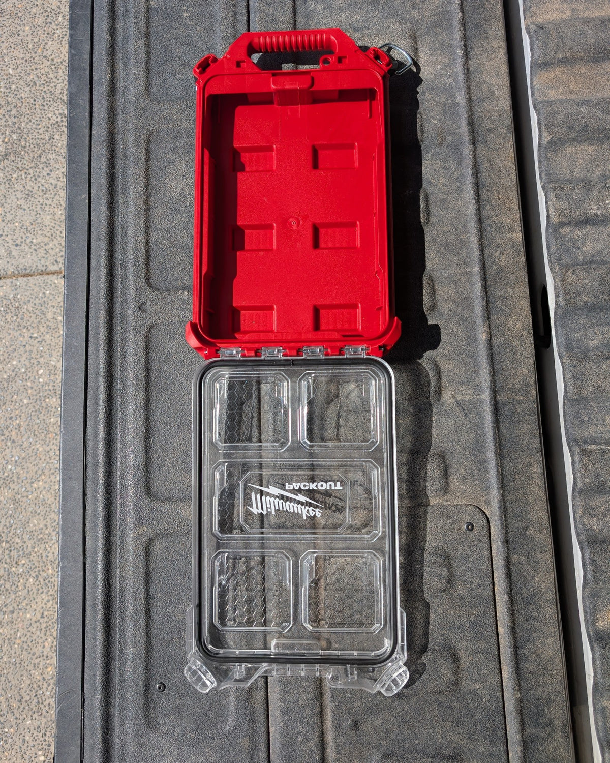 Empty red Milwaukee Packout 48-22-8436 compact low-profile organizer case open with clear lid