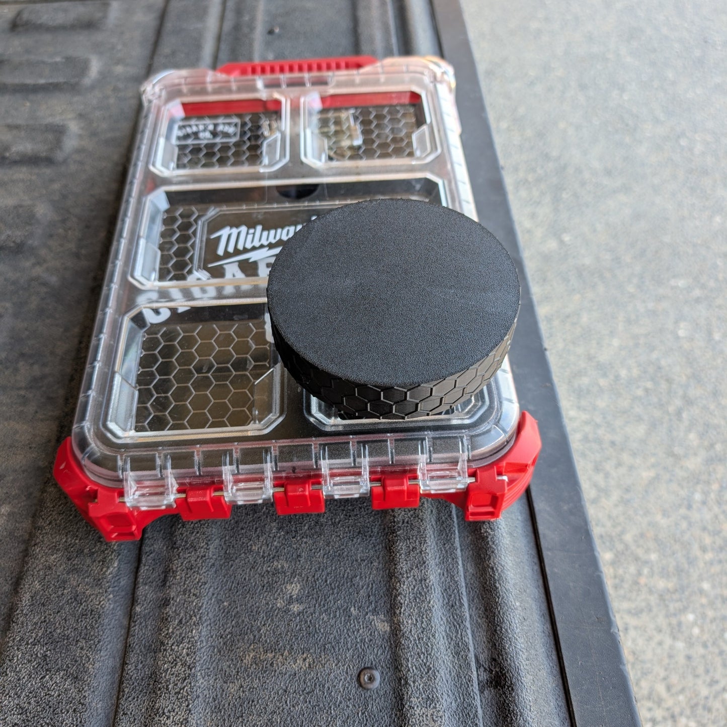 Closed stainless steel modular ashtray attachment with black textured cap mounted on Milwaukee Packout 48-22-8436 organizer lid