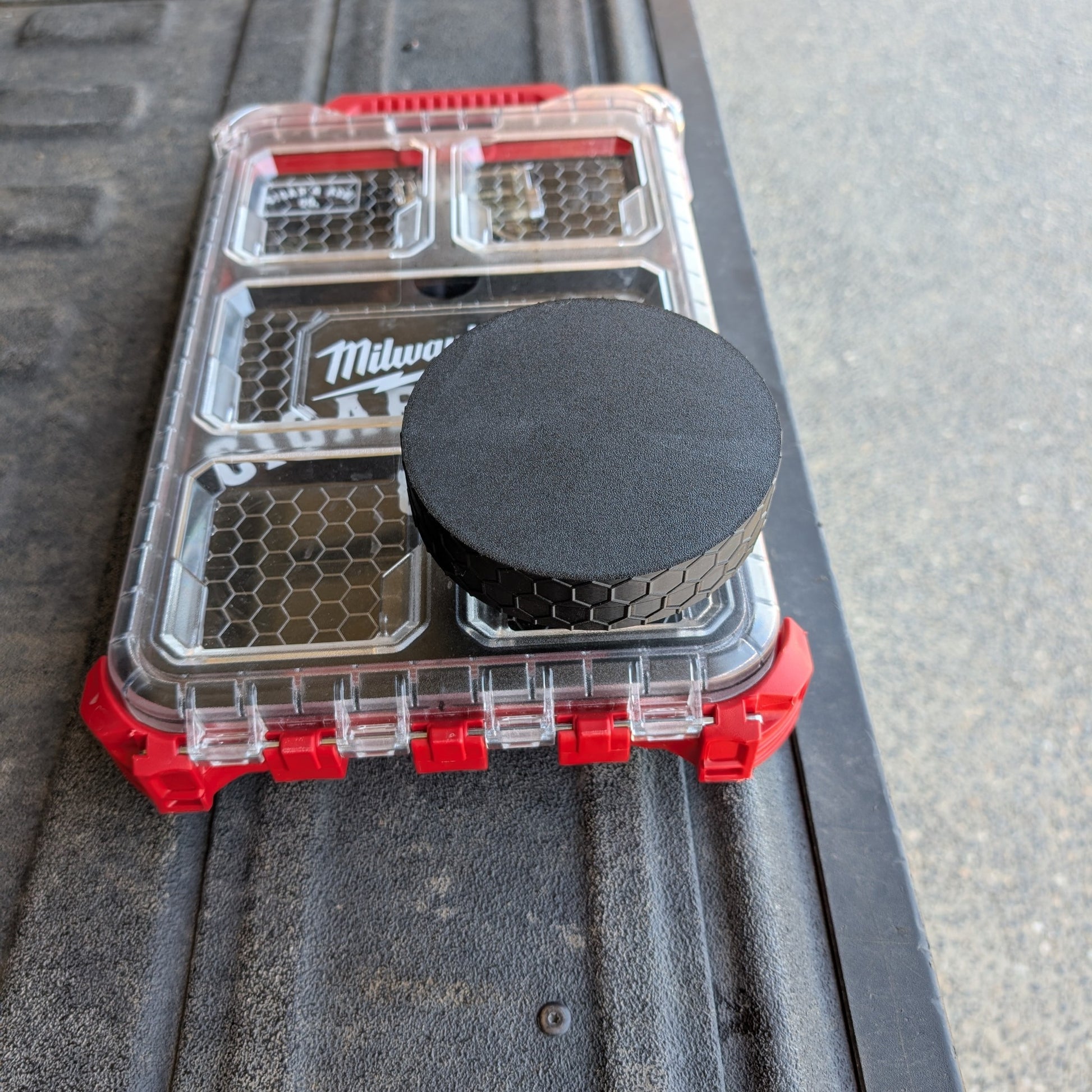 Closed stainless steel modular ashtray attachment with black textured cap mounted on Milwaukee Packout 48-22-8436 organizer lid