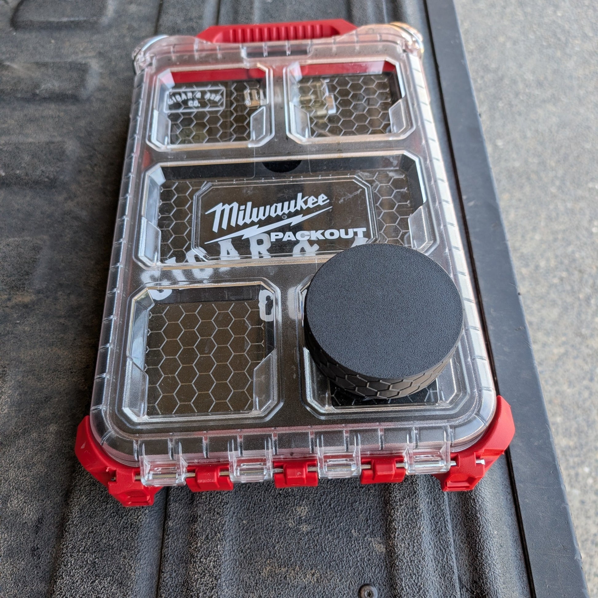 Closed black textured pouch attachment mounted on a Milwaukee Packout case with Cigar & Ash Co. insert